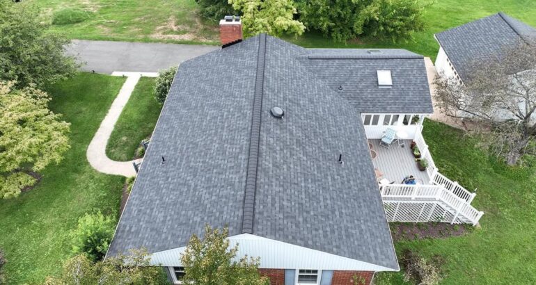 Completed asphalt shingle roof on a single-story brick home