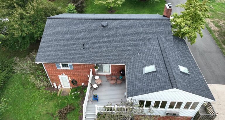 Residential roof replacement on a brick home with gray shingles