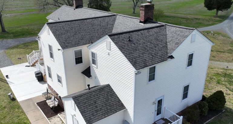 Finished residential roof replacement with dark shingles