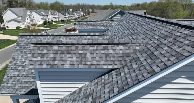 Close-up of a completed residential roof with gray shingles